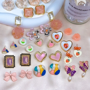 Pink heart and flower earrings collection with pearls on soft pink satin fabric