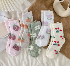 Detail of coral fleece socks with strawberry, tulip and daisy floral patterns