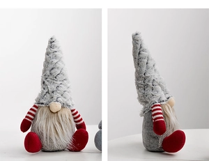 Close-up of Christmas gnome plush with red striped sleeves and long white beard detail