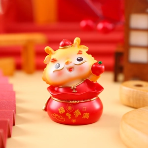 Detail view of a Chinese dragon figurine with Fu character on a resin money bag base