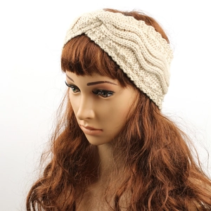 Detail of beige fleece-lined knitted headband with twist knot and wave texture