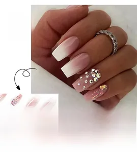 Detail of pink ombre press-on nails with luxury rhinestones and glitter in coffin shape