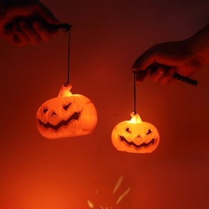 Glowing LED pumpkin lanterns with handheld poles for Halloween atmosphere.