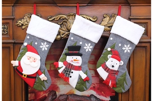 Three grey felt Christmas stockings with 3D Santa Snowman and Bear on a fireplace