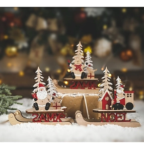 Detailed view of wooden Christmas sleigh ornaments with Santa and reindeer on faux snow