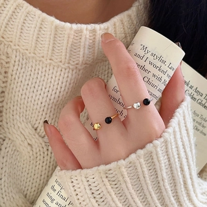 Minimalist 925 sterling silver open ring with black agate bead on a model hand