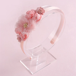 Detailed view of pink floral headband with delicate mesh lace and fabric flowers