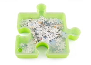 Green puzzle-shaped organizer box with transparent lid and lettered puzzle pieces