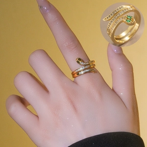 Vintage gold snake ring featuring emerald green zircon eyes and crystal stone scales