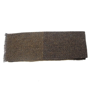 Detail of a brown tweed scarf with fringed edges, showing woven texture and soft fabric