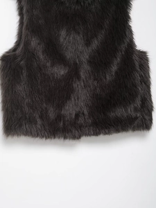 Close-up of premium black faux fur vest showing soft texture and fluffy synthetic hair detail