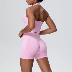 Rear view of pink seamless high-waist yoga shorts and halter open-back sports bra set