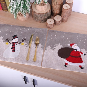 Christmas place mats set featuring Santa and Snowman designs on rustic linen fabric