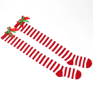 Detail of festive red and white striped over-knee socks with holiday bow accents