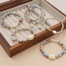 Detailed macro view of bohemian beaded bracelets with natural stones in a wooden jewelry box
