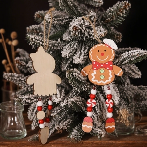 Christmas wooden gingerbread man ornaments with long beaded legs on a festive tree branch