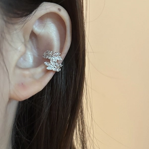 Silver leaf cuff earring with zircons for non-pierced ears shown on a female ear