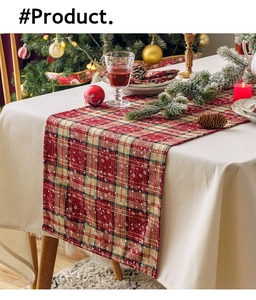 Macro detail of red and green plaid table runner with snowflake print for Christmas
