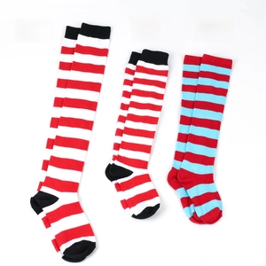 Detailed view of striped knit long socks for adults and children in red, blue, and white
