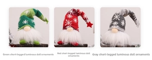 Detailed view of three knitted Christmas gnomes with warm LED lights and snowflake patterns