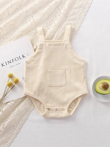 Breathable ribbed cotton baby bodysuit in beige with a front pocket and snap buttons