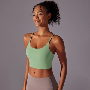 Detail of mint green high-impact sports bra with thin straps and sleek nylon fabric