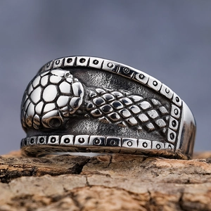 Vintage gothic snake-scale engraved stainless steel ring on natural wood bark base