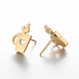 Macro view of gold coffee cup stud earring with heart cutout and steam detail