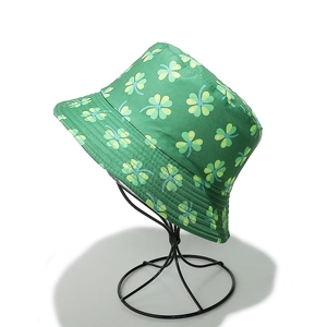 Detailed view of green bucket hat with clover pattern and reinforced brim stitching