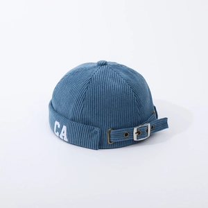 Detail of blue corduroy brimless docker hat featuring CA embroidery and adjustable metal buckle