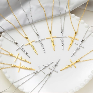 Detail showing cross-shaped pendants engraved with trust, hope, and love on a tray