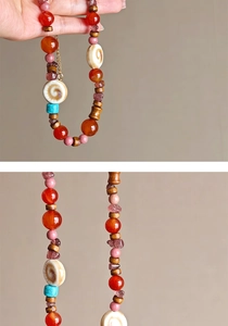 Detailed macro view of an irregular beaded necklace with agate and ceramic beads