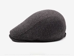 Detail view of the thick wool blend fabric texture on the dark grey beret side profile