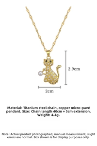 Detail of gold cat pendant necklace featuring white pearls and zircon pavé on steel chain