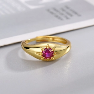 Vintage gold plated open ring featuring a round red gemstone with starburst engraving