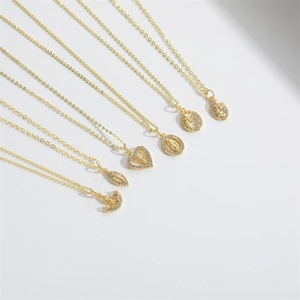 Golden religious pendant necklaces set with white crystals on a sleek link chain