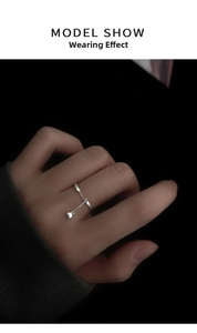 Minimalist 925 silver plated chain ring with a small ball pendant worn by a model