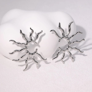 Detailed close-up of sunburst earrings in silver polished finish on artistic base