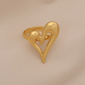 Elegant gold-plated heart-shaped open ring with faux pearl on a beige velvet background