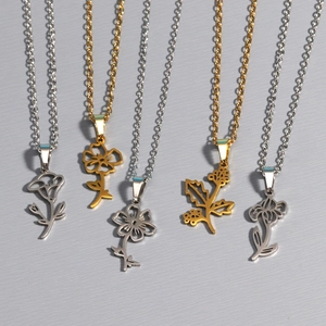 Detail showing six floral pendant necklaces in gold and silver finishes on fine O-chains