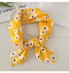 Detailed texture of yellow linen cotton scarf featuring white daisy floral pattern print