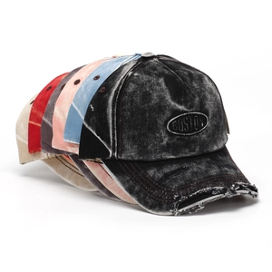 Detailed view of frayed edges and worn-out texture on vintage washed baseball caps