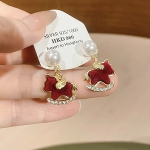 Detail of red rocking horse earring with pearls, rhinestones, and 925 silver needle