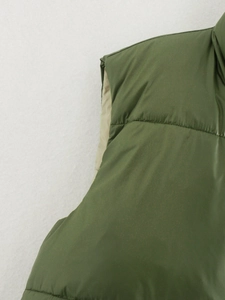 Detailed close-up of stitching on olive green windproof vest shoulder and armhole
