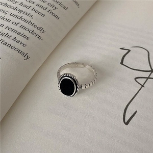 Detailed close-up of retro 925 sterling silver adjustable ring with oval black agate