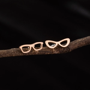 Polished rose gold stainless steel earrings with unique glasses design on a branch