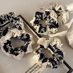 Detailed embroidery of daisy patterns and lace hollow edges on cotton hair scrunchies