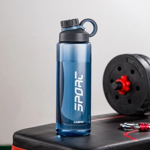Blue plastic sports water bottle with sport logo on a gym weight bench detail