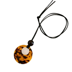 Irregular hollow amber pendant necklace with silver metal accent and black cord