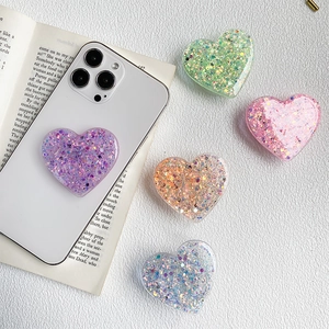 Sparkling glitter heart phone grip and stand for comfortable handheld use and desktop support